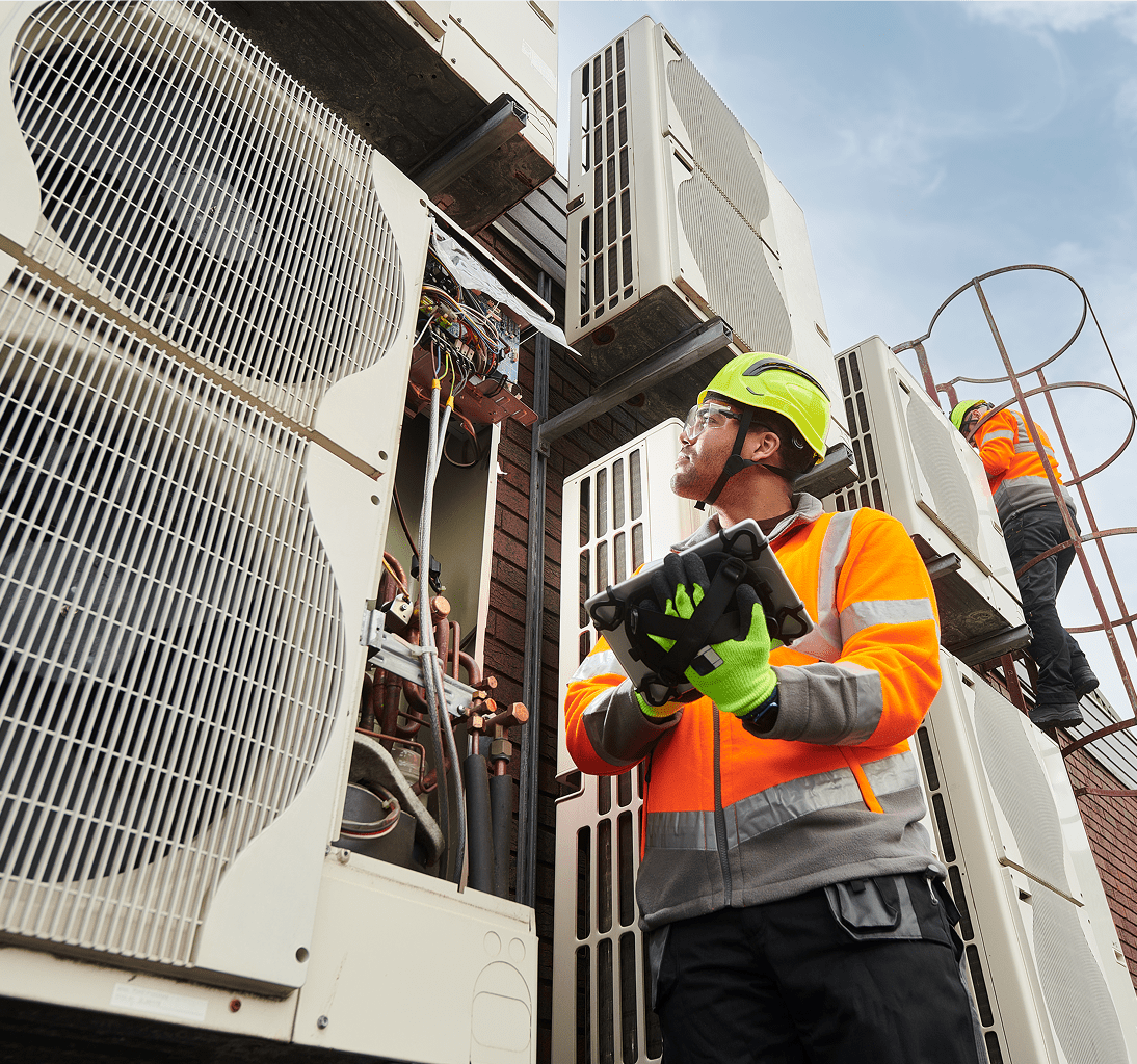 Engineers examining outdoor cooling equipment