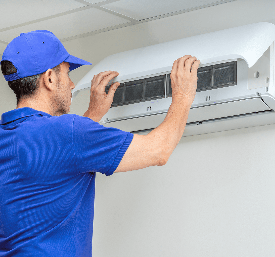 Technician inspecting wall-mounted air conditioner